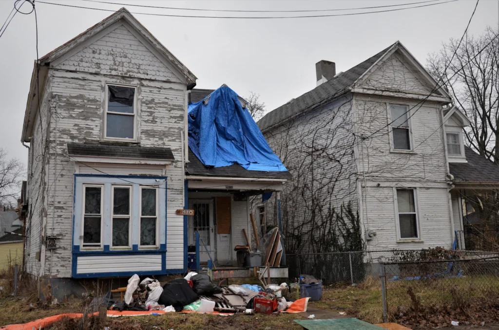 Blue tarp covering a damaged section of a house roof